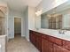 Elegant bathroom boasts double sinks, tile flooring, walk-in closet access, and a tiled glass door shower at 4425 Marlay Park, Indian Trail, NC 28079