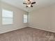 Bright bedroom with carpet, two windows providing lots of natural light, and a ceiling fan at 4425 Marlay Park, Indian Trail, NC 28079