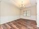 Well-lit dining room with hardwood floors, wainscoting, and a decorative chandelier at 4425 Marlay Park, Indian Trail, NC 28079