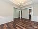 Stylish dining area featuring hardwood floors, wainscoting, decorative pillars, and an open floor plan at 4425 Marlay Park, Indian Trail, NC 28079