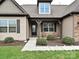 Inviting front porch with rocking chairs, stylish front door, and well-manicured landscaping at 4425 Marlay Park, Indian Trail, NC 28079