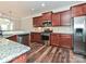 Kitchen with stainless steel appliances, granite countertops, wood cabinets, and hardwood floors at 4425 Marlay Park, Indian Trail, NC 28079