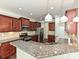 Well-lit kitchen featuring stainless steel appliances, granite countertops, and stylish cabinetry with hardwood floors at 4425 Marlay Park, Indian Trail, NC 28079