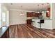 Open concept kitchen with stainless steel appliances, granite countertops, a breakfast bar, and hardwood floors at 4425 Marlay Park, Indian Trail, NC 28079