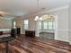Open-concept living area with hardwood floors, fireplace, and view into a sunroom at 4425 Marlay Park, Indian Trail, NC 28079