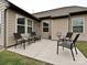 Concrete patio with black metal patio furniture provides an outdoor entertaining space at 4425 Marlay Park, Indian Trail, NC 28079