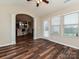 Sunroom leading to an open-concept layout with hardwood floors, a view into the kitchen, and outdoor access at 4425 Marlay Park, Indian Trail, NC 28079
