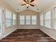 Bright sunroom with multiple windows, hardwood floors, and a ceiling fan at 4425 Marlay Park, Indian Trail, NC 28079