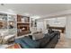 Finished basement featuring a brick fireplace, bookshelves, pool table, and comfortable seating at 5125 Winding Brook Rd, Charlotte, NC 28226