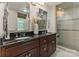 Bathroom featuring dual sinks, granite counters, and a glass shower enclosure at 5125 Winding Brook Rd, Charlotte, NC 28226
