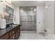 Modern bathroom featuring glass shower enclosure, granite counters, and modern fixtures at 5125 Winding Brook Rd, Charlotte, NC 28226