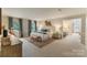 Bright main bedroom with carpet floor, blue accents, and an adjoining sitting area at 5125 Winding Brook Rd, Charlotte, NC 28226
