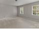 Bedroom with carpet flooring and large windows that flood the room with natural light at 5125 Winding Brook Rd, Charlotte, NC 28226