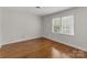 Bedroom with hardwood floors and natural light from the window at 5125 Winding Brook Rd, Charlotte, NC 28226