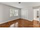 Bright bedroom with hardwood floors, a large window and closet space providing an open airy feel at 5125 Winding Brook Rd, Charlotte, NC 28226