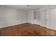 Bedroom with hardwood floors, a closet and natural light from the large window at 5125 Winding Brook Rd, Charlotte, NC 28226