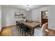 Bright dining room with a large wooden table and view to kitchen at 5125 Winding Brook Rd, Charlotte, NC 28226