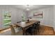 Bright dining room with a large wooden table and a modern light fixture at 5125 Winding Brook Rd, Charlotte, NC 28226