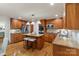 Well-equipped kitchen featuring granite countertops, wood cabinets, and modern appliances at 5125 Winding Brook Rd, Charlotte, NC 28226