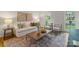Cozy living room with natural light, stylish furnishings, and hardwood floors at 5125 Winding Brook Rd, Charlotte, NC 28226