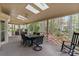 Comfortable screened-in porch with a table, chairs, and view of the lush yard at 5125 Winding Brook Rd, Charlotte, NC 28226