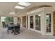 Spacious screened-in porch with an outdoor dining area, rocking chair and brick exterior at 5125 Winding Brook Rd, Charlotte, NC 28226