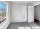 Cozy bedroom with plush carpeting, a bright window, and two closets at 5407 Windy Valley Dr, Charlotte, NC 28208
