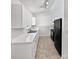 Efficient kitchen featuring white cabinets, sleek black appliances, and durable countertops with a breakfast bar at 5407 Windy Valley Dr, Charlotte, NC 28208
