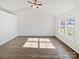 Large main bedroom featuring hardwood floors, vaulted ceiling, and large, bright windows at 5407 Windy Valley Dr, Charlotte, NC 28208