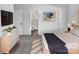 Serene bedroom with modern decor, including a sleek dresser and artwork, leading into an ensuite bathroom at 5407 Windy Valley Dr, Charlotte, NC 28208