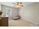 Bright bedroom with neutral walls, a ceiling fan, and a window overlooking the backyard at 5622 Dartington Dr, Indian Land, SC 29707