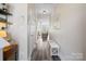 Hallway with hardwood-style floors leading to a cozy living space, enhanced by a neutral color palette at 5622 Dartington Dr, Indian Land, SC 29707