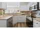 Well-lit kitchen featuring white cabinets, stainless steel appliances, and ample counter space at 5622 Dartington Dr, Indian Land, SC 29707