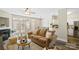 Bright, open living room with a comfortable sofa, fireplace, and natural light, perfect for relaxing at 5622 Dartington Dr, Indian Land, SC 29707