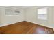 This bedroom features two windows, hardwood floors and neutral colored walls at 5876 Wedgewood Dr, Charlotte, NC 28210