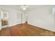 This bright bedroom features hardwood floors, white walls, base molding, a closet and an ensuite bathroom at 5876 Wedgewood Dr, Charlotte, NC 28210
