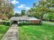 Charming home with a covered carport, brick facade, and lush green lawn, showcasing its classic curb appeal at 5876 Wedgewood Dr, Charlotte, NC 28210