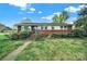 Charming single story brick home featuring mature landscaping and a walkway leading to the front door at 5876 Wedgewood Dr, Charlotte, NC 28210