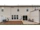 The backyard has grass and a patio area with a building in the background at 5951 Carrollton Ln, Charlotte, NC 28210