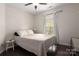 This bedroom features dark wood floors, neutral walls, ceiling fan, and window that adds natural light at 5951 Carrollton Ln, Charlotte, NC 28210