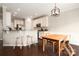 Eat-in kitchen with stainless appliances, granite countertops, a breakfast bar, and dark hardwood floors at 5951 Carrollton Ln, Charlotte, NC 28210