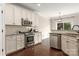 Modern kitchen with stainless steel appliances, granite countertops, white cabinets, and hardwood floors at 5951 Carrollton Ln, Charlotte, NC 28210