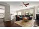Open living room with a fireplace, hardwood floors, recessed lighting, and access to the kitchen at 5951 Carrollton Ln, Charlotte, NC 28210