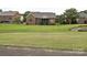 Landscaped backyard with view of a brick home and a charming screened-in porch at 6144 Abergele Ln, Matthews, NC 28104