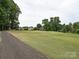Expansive backyard view showcasing neighborhood homes and lush green spaces at 6144 Abergele Ln, Matthews, NC 28104