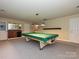 Spacious finished basement featuring a billiards table and a wet bar, perfect for entertaining at 6144 Abergele Ln, Matthews, NC 28104