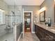 Well-appointed bathroom featuring glass shower, dual vanity with granite counters, and tile flooring at 6144 Abergele Ln, Matthews, NC 28104