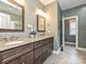Elegant bathroom with double vanity, granite countertop, framed mirrors, and stylish fixtures at 6144 Abergele Ln, Matthews, NC 28104