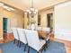 Open dining room with a modern chandelier and views to the kitchen and office at 6144 Abergele Ln, Matthews, NC 28104