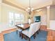Elegant dining room with tray ceiling, stylish chandelier and shuttered windows at 6144 Abergele Ln, Matthews, NC 28104